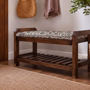 a wooden bench with a woven seat and a wooden shelf underneath, placed in a room with a woven basket and a potted plant.