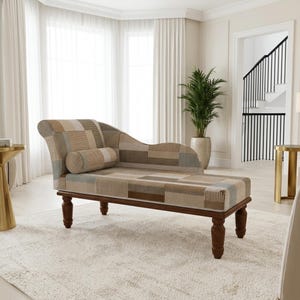 May include: A chaise lounge featuring a patchwork upholstery pattern in shades of beige, brown, and light blue. The furniture piece has a curved backrest, a cylindrical bolster pillow, and is supported by four dark brown turned wooden legs.