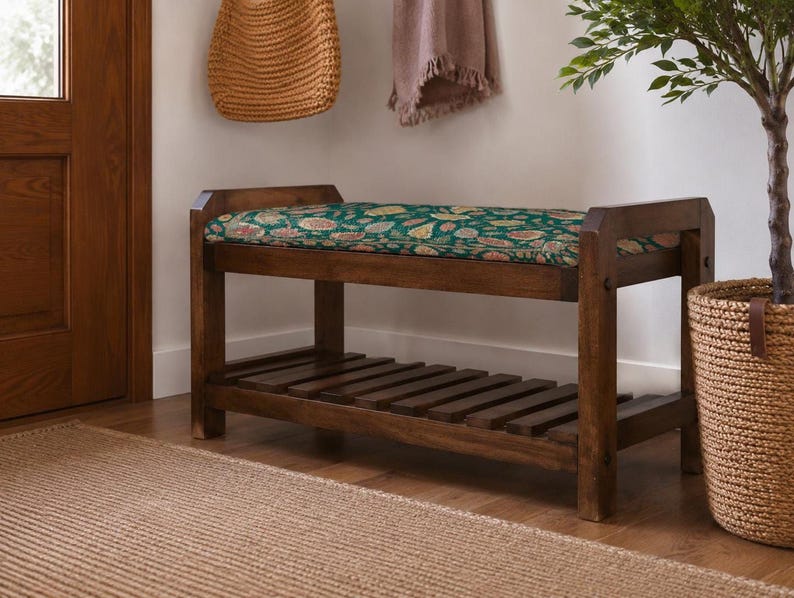 a wooden bench with a colorful floral patterned cushion, placed on a wooden floor next to a woven basket and a potted plant.