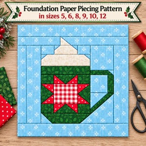 May include: A foundation paper piecing pattern featuring a mug design with a red and white gingham star, green holly fabric, and a cream-colored top. The text reads Foundation Paper Piecing Pattern in sizes 5, 6, 8, 9, 10, 12.