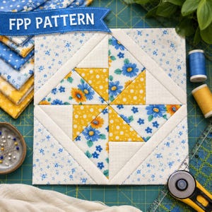 May include: A square quilt block featuring a central pinwheel design made of yellow and blue floral fabric, surrounded by white fabric borders. The block is displayed on a green cutting mat with a blue banner reading FPP PATTERN.