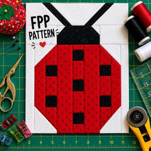 May include: A quilt block pattern featuring a ladybug design with red fabric with black dots and black fabric with floral patterns. The text FPP PATTERN and a red heart are printed on the white background. The block is surrounded by sewing tools.