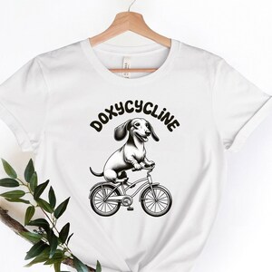 Biking Dachshund Doxycycline T-Shirt | Pharmacists Shirt | Veterinary | Vet Tech | Vet Shirt | Vet Tech Gift | Veterinarian | Technician Tee