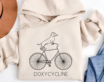 Doxycycline Pharmacie Pun Hoodie | Teckel à vélo | Sweat à capuche pour pharmaciens | Vétérinaire | Cadeau de pharmacie | Cadeau pharmaciens et techniciens