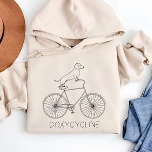 Doxycycline Pharmacy Pun Hoodie | Dachshund on Bicycle | Pharmacists Hoodie | Veterinary | Pharmacy Gift | Pharmacists & Technicians Gift