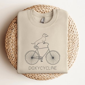 Doxycycline Pharmacy Pun Sweatshirt | Dachshund on Bicycle | Pharmacists Shirt | Veterinary | Pharmacy Gift | Pharmacists & Technicians Gift