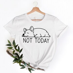 May include: White t-shirt with a black line drawing of a sleeping dog and the text "NOT TODAY".