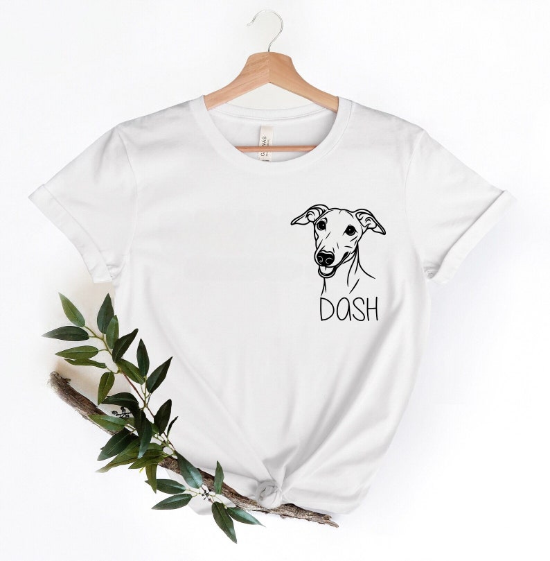 May include: White t-shirt with a black and white illustration of a dog's head and the word "DASH" printed below it.