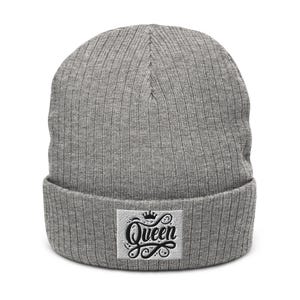 May include: Gray knitted beanie with a white patch that says "Queen" in black script with a crown above the word.