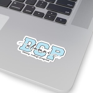 May include: A blue and white sticker with the text "DCP alumni" and "Disney College Program" in black lettering.