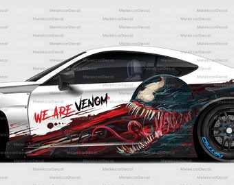 May include: White car with a black and red Venom graphic wrap. The car has a large black Venom head graphic on the side with the words "We Are Venom" in red. The car has black wheels with blue accents.