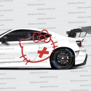 May include: White sports car with a large rear wing and black wheels. A red cartoon cat graphic with a cross is on the side. The car has a sleek, aerodynamic design.