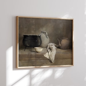 May include: A framed painting depicting a still life with a black cast iron pot, a white ceramic jug, a brown ceramic teapot, and a white ceramic bowl on a wooden table. The painting has a brown background.