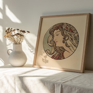 May include: A framed print of a woman with long flowing hair, wearing a red and gold crown. The woman is depicted in a circle with a blue and green background. The print is in a wooden frame.