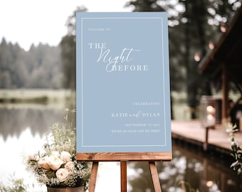 May include: A light blue welcome sign with white text that reads "Welcome to The Night Before Celebrating Katie and Dylan September 15, 2024 We're so glad you're here!" The sign is on a wooden easel.