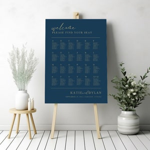 May include: A navy blue wedding seating chart with gold lettering. The chart is titled "Welcome" and "Please Find Your Seat". The chart lists alphabetical seating assignments for guests. The bottom of the chart reads "Katie & Dylan" and "September 13, 2024 | Calgary, Canada".