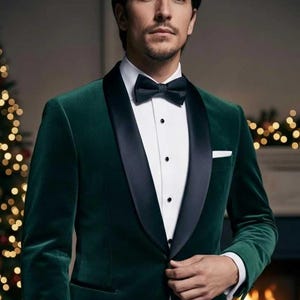 May include: A dark green velvet tuxedo jacket with a black satin lapel, worn over a white dress shirt and a black bow tie. The jacket has a tailored fit and a pocket square. The background includes a Christmas tree and a fireplace.