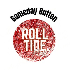 May include: A round, red glitter button with the words "Roll Tide" in white block letters. The button also has the words "Gameday Button" in black, curved text above the circle. A small bow is visible on the left side of the button.