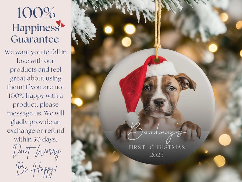 May include: A round Christmas ornament featuring a puppy wearing a Santa hat. The ornament has the text "Bailey's First Christmas 2025". The background is a blurred image of a Christmas tree.
