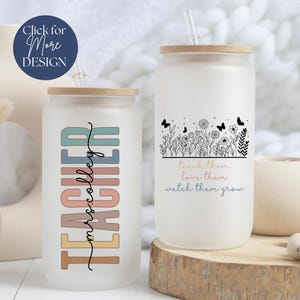 May include: Two frosted glass tumblers with lids and straws. One tumbler has the text "Teacher" in rainbow colors with the words "mrs.colley" written in cursive underneath. The other tumbler has a black and white illustration of flowers and butterflies with the text "teach them, love them, watch them grow".