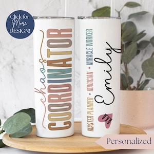 May include: Two white stainless steel tumblers with lids and straws. The tumbler on the left has the text "chaos coordinator" in rainbow colors. The tumbler on the right has the text "Master Planner - Magician - Miracle Worker" and the name "Emily" in black script. The tumbler on the right also has a pink heart with the text "#boss" inside.