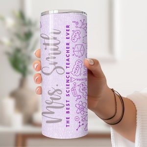 May include: A light purple stainless steel travel mug with the text "Mrs. Smith THE BEST SCIENCE TEACHER EVER" in silver. The mug has purple science-themed doodles. A thoughtful gift for a science teacher.