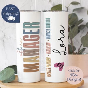 May include: Two white stainless steel tumblers with colorful text. The tumbler on the left says "office MANAGER" in rainbow colors. The tumbler on the right says "MASTER PLANNER MAGICIAN - MIRACLE WORKER" in black text and "Lora" in black cursive text.