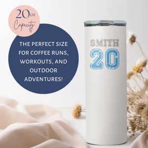 May include: White stainless steel tumbler with a blue and white graphic that says "SMITH 20". The tumbler is 20 ounces and has a white background.