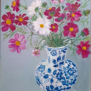 May include: A blue and white porcelain vase with a floral pattern holds a bouquet of pink and white cosmos flowers against a light blue background.