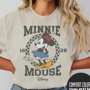 a woman wearing a minnie mouse t - shirt