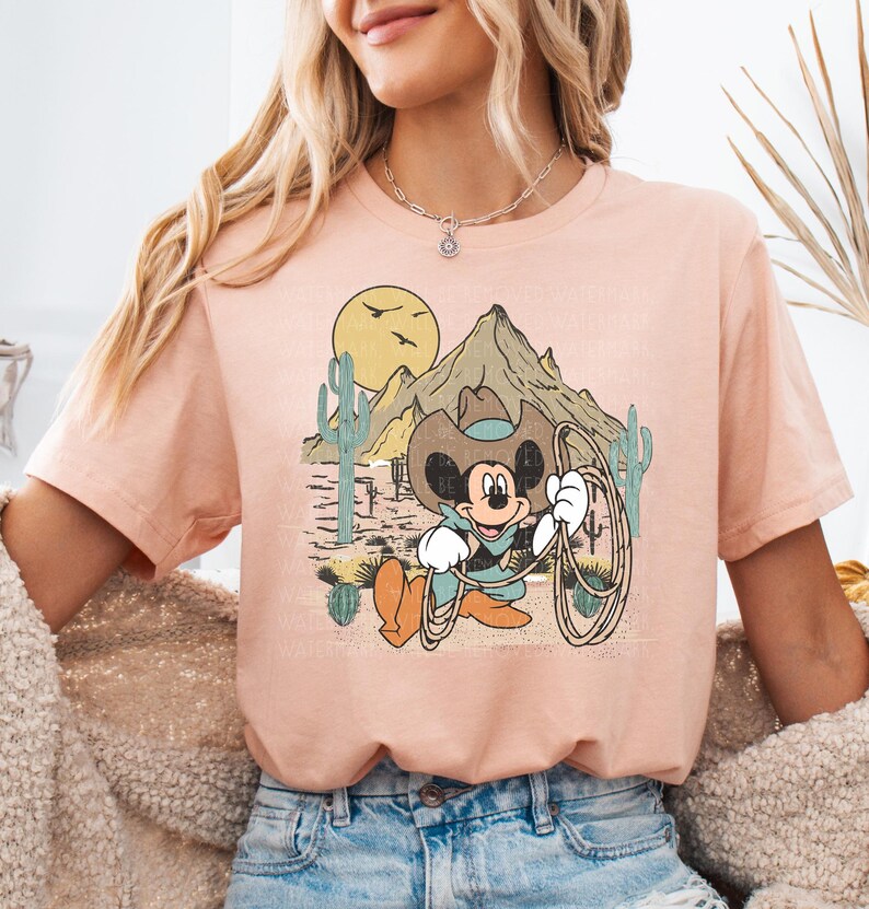 a woman wearing a pink shirt with a cartoon character on it