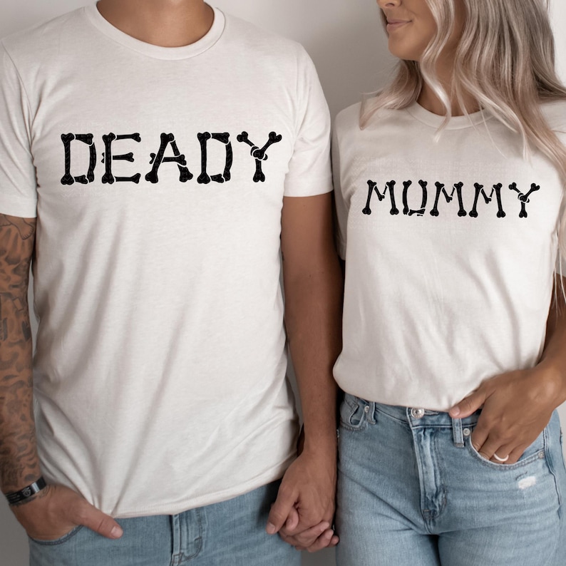 A man and a woman wearing matching t-shirts with the word "DEADY" and "MUMMY" printed on them.