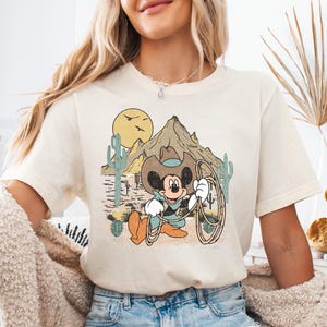 a woman wearing a mickey mouse t - shirt