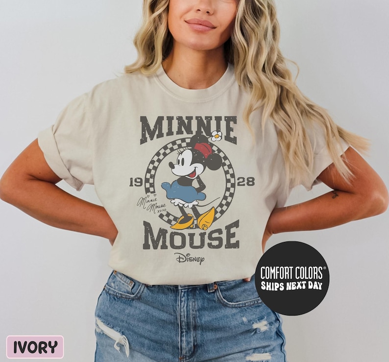 a woman wearing a minnie mouse t - shirt