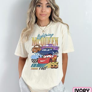 a woman wearing a t - shirt with cars on it