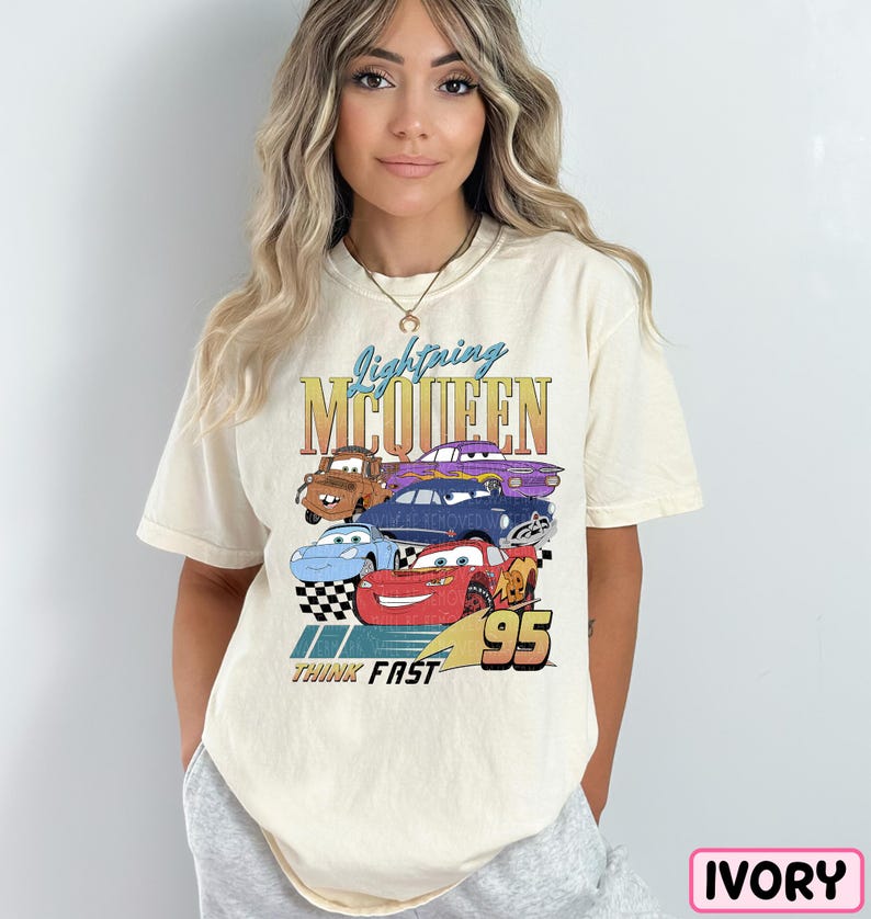 a woman wearing a t - shirt with cars on it