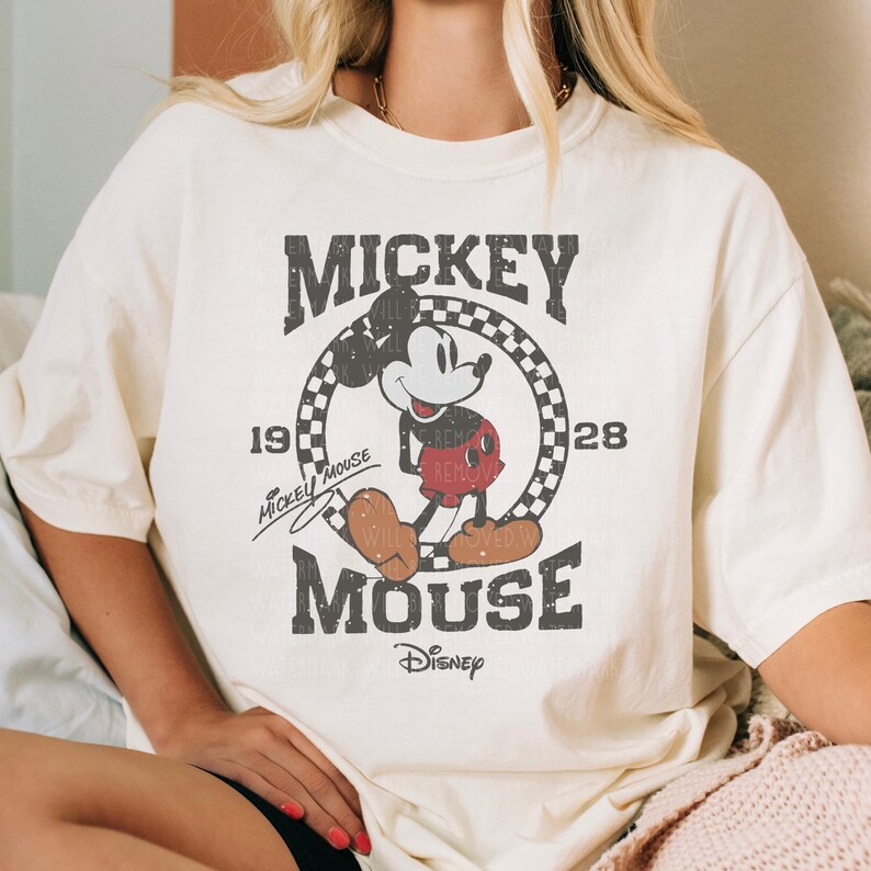 A white t-shirt with a graphic of Mickey Mouse and text that reads " Mickey Mouse" and "Disney".