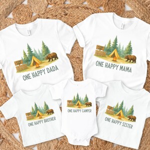 a group of three onesuits with a picture of a camper and a