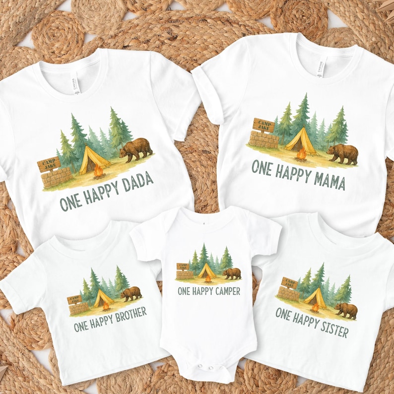 a group of three onesuits with a picture of a camper and a