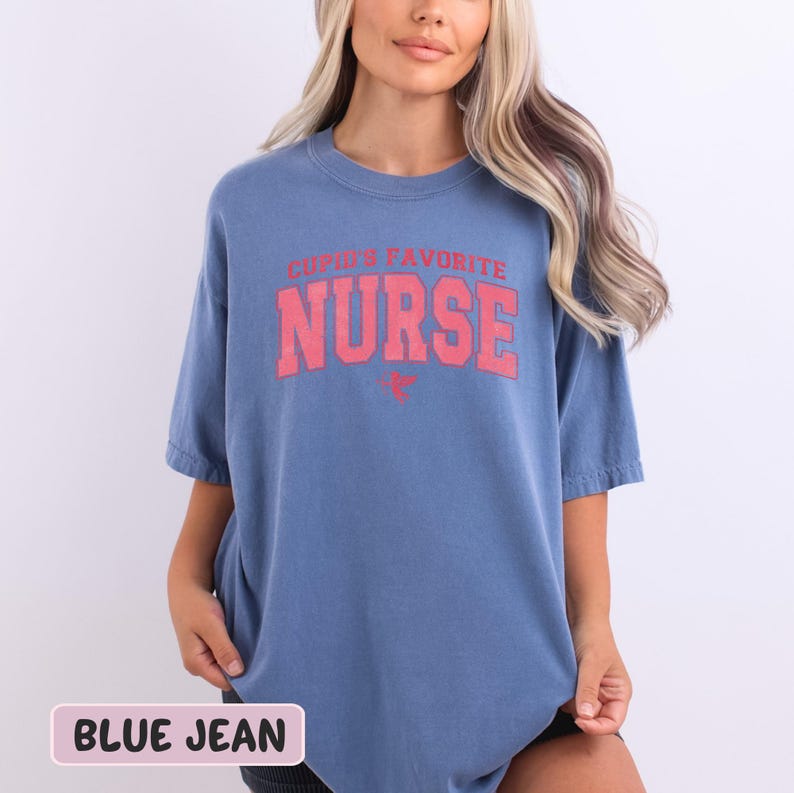 a woman wearing a blue t - shirt with the words nurse on it