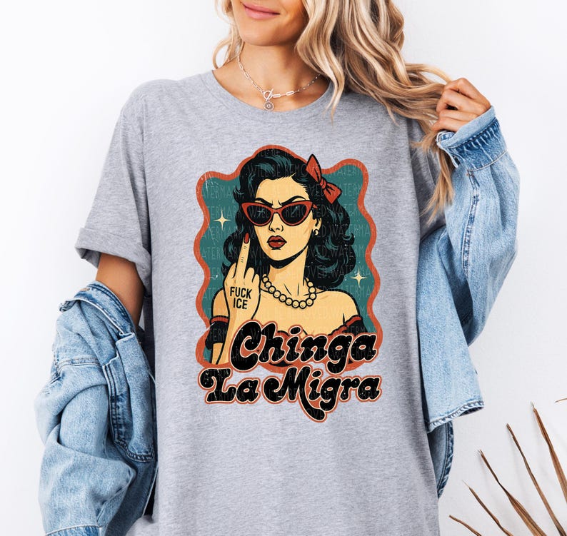 a woman wearing a gray shirt with a picture of a woman wearing sunglasses
