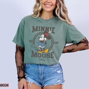 a woman wearing a minnie mouse t - shirt