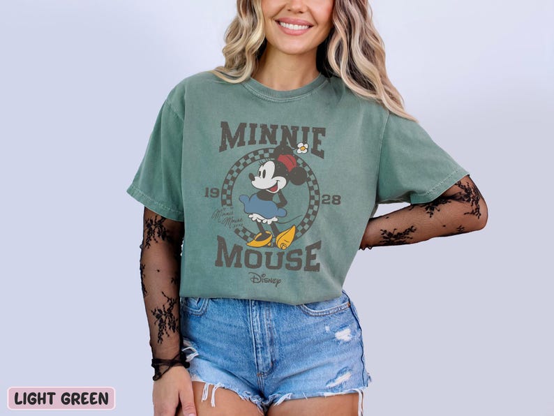 a woman wearing a minnie mouse t - shirt