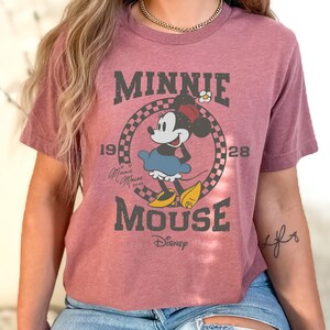 a woman wearing a minnie mouse t - shirt