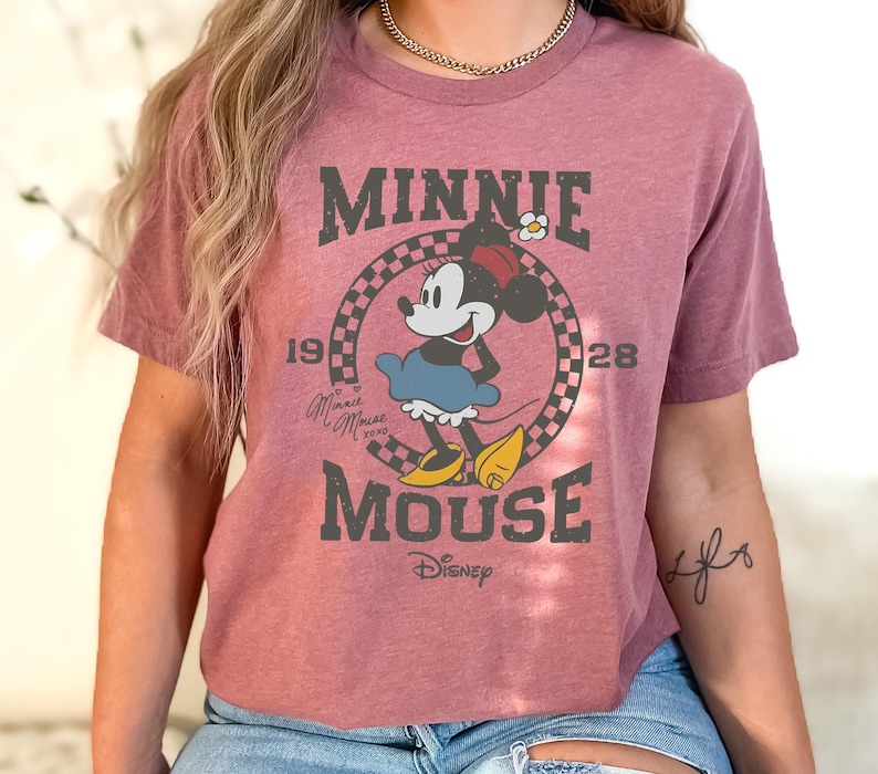 a woman wearing a minnie mouse t - shirt
