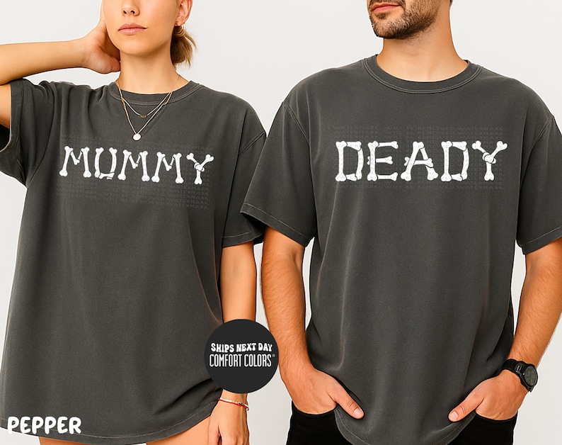 A man and a woman wearing matching t-shirts with the word "MUMMY" and "DEADY" printed on them, posing together.