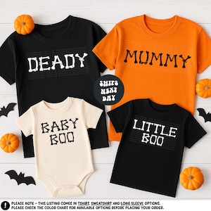 a collection of Halloween-themed t-shirts, including a black t-shirt with the text "DEADY" and an orange t-shirt with the text "MUMMY". There are also two baby t-shirts, one in white and one in black, with the text "BABY BOO" printed on them. The t-shirts are arranged on a white background, and there are small orange pumpkins scattered around the display.