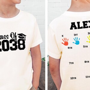 a young boy wearing a class of 208 shirt