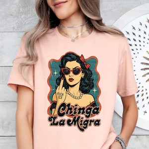 a woman wearing a pink tshirt with a picture of a woman's