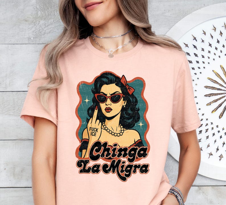 a woman wearing a pink tshirt with a picture of a woman's